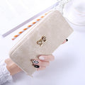 The long hand in the lady's purse holds the bag of the zipper key card